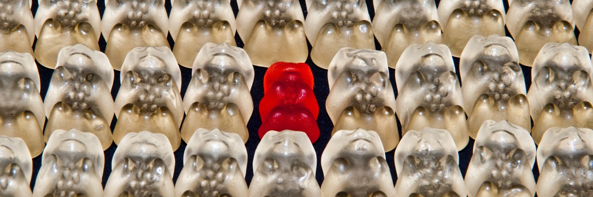 white gummy bears with one red gummy bear