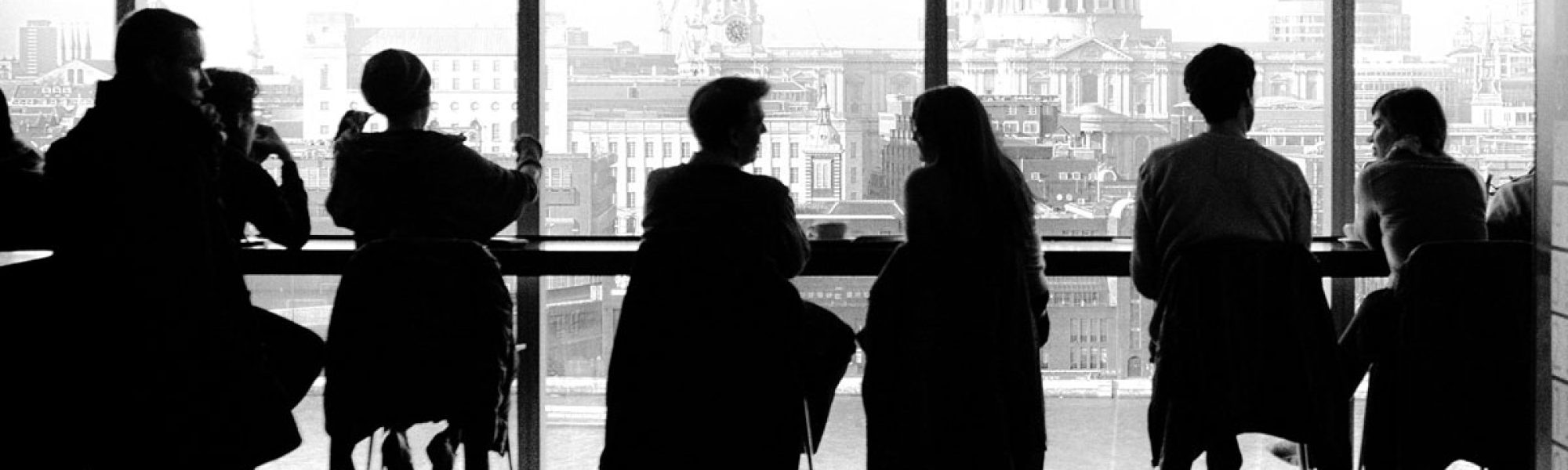 silhouettes of people sitting near window