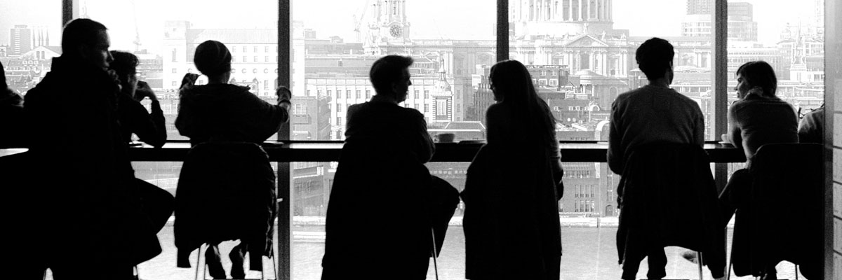 silhouettes of people sitting near window