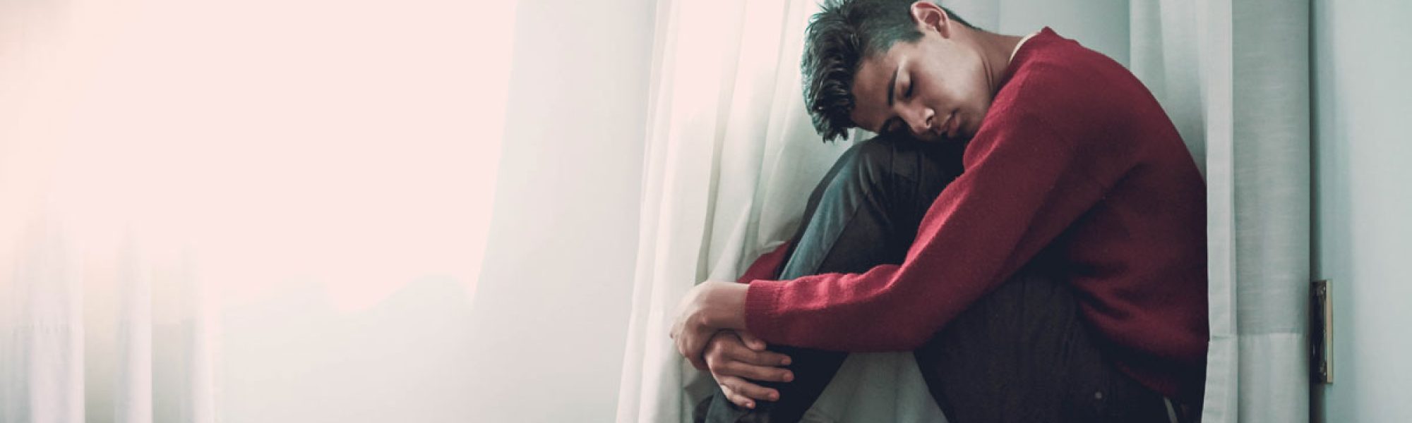 upset man sitting on floor