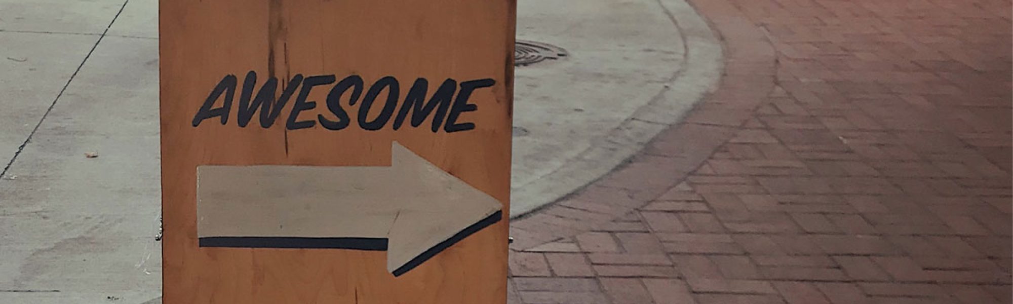 sidewalk sign saying "awesome"